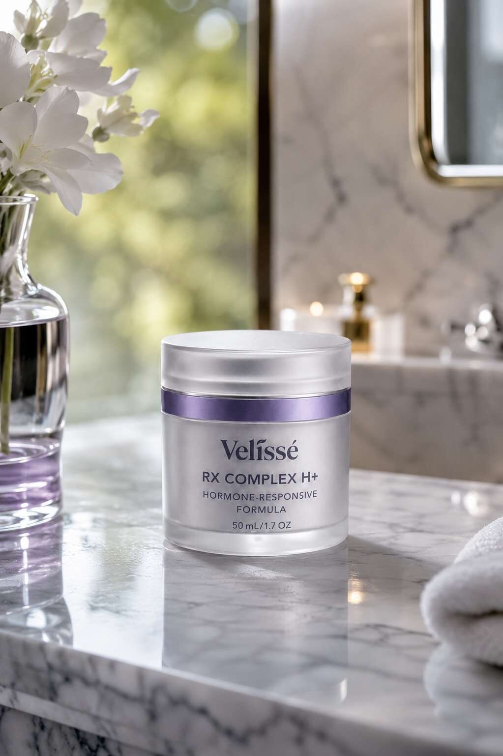 Woman applying Velissé RX Complex H+ at bathroom mirror